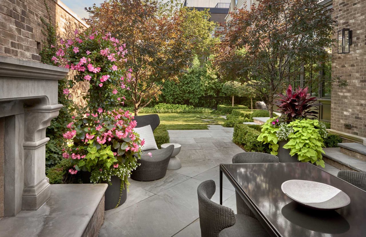 Private city backyard with a outdoor fireplace, dining area on a bluestone patio.