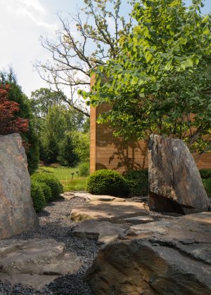 Irregular boulder creating path into backyard