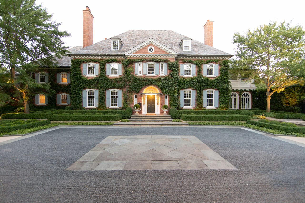 Formal residential entrance with symmetrical linear boxwood hedges, bluestone curbs, steps and paving.