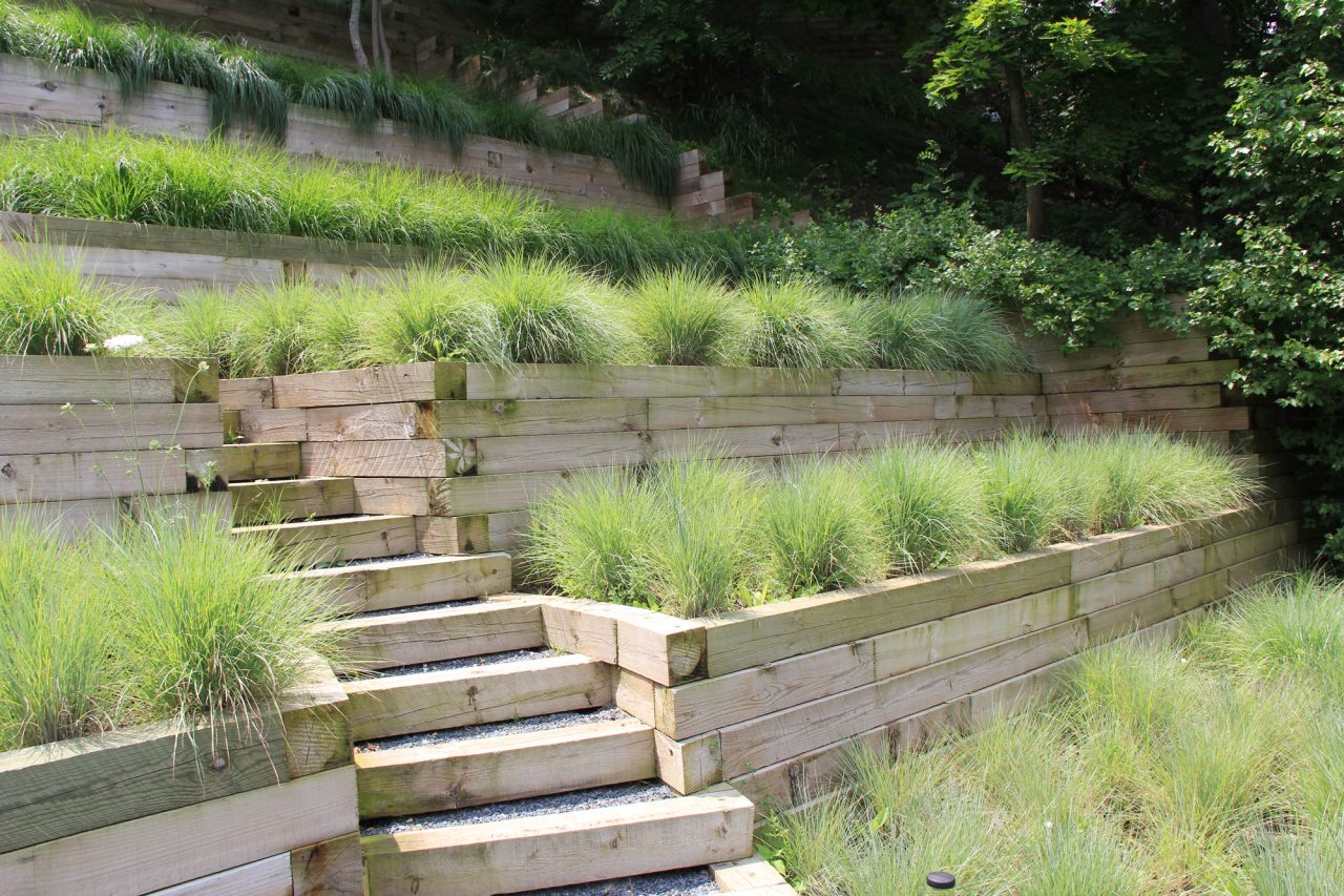 Timber steps at timber walls with glass flower boxes on bluff