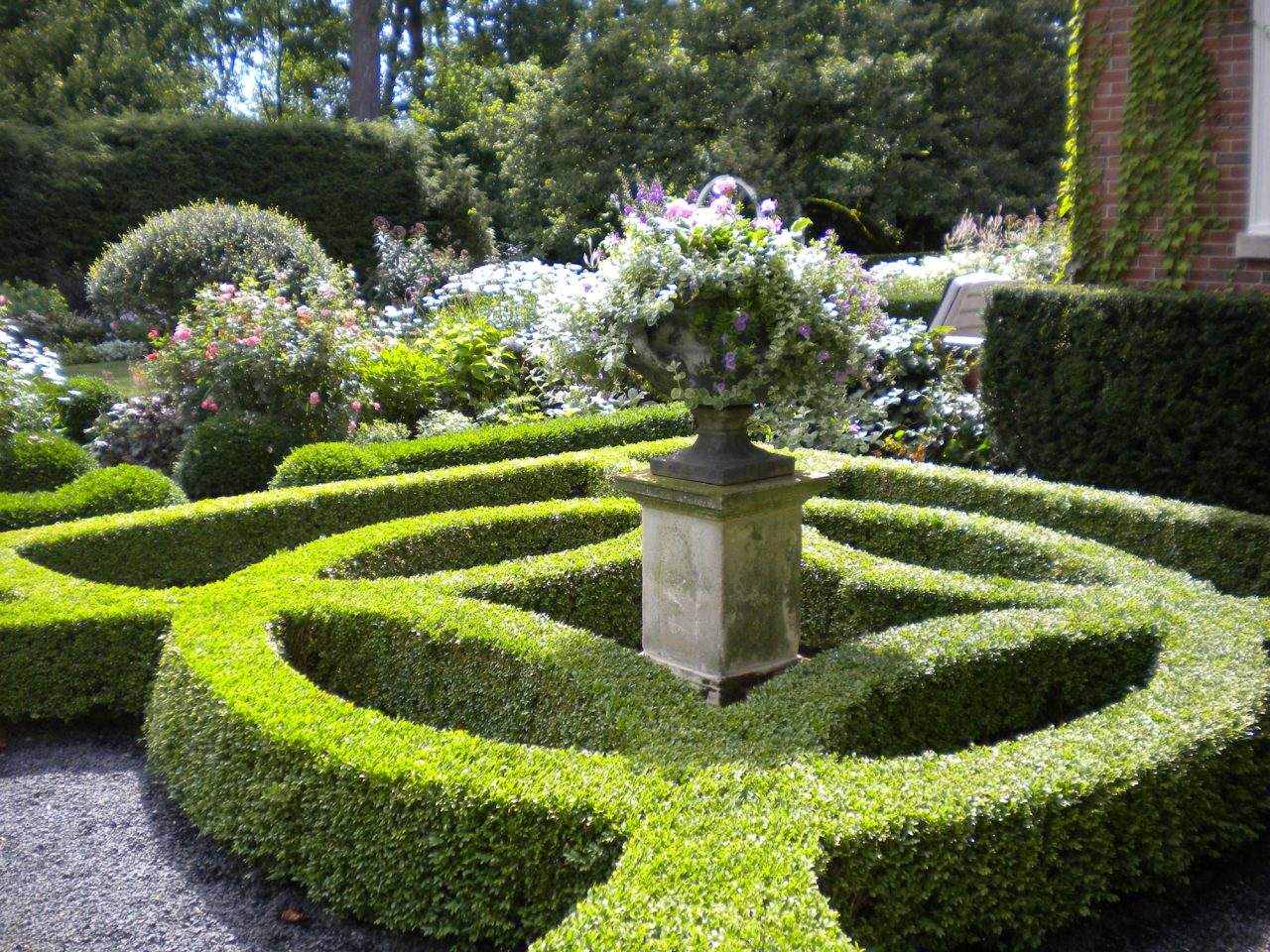 Boxwood Parterre in Perennial Garden with lead urn atop a limestone pedestal