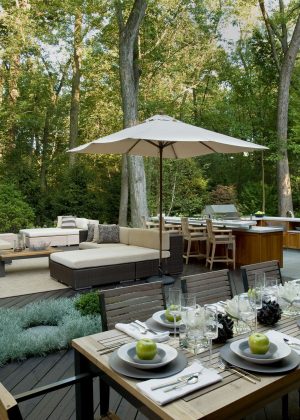 Contemporary outdoor kitchen with shade trees for hostings