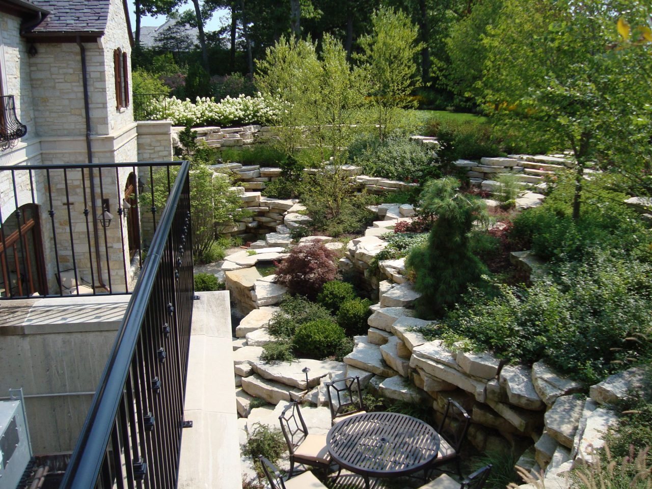 Sunken garden with ledgerock outcroppings and water features