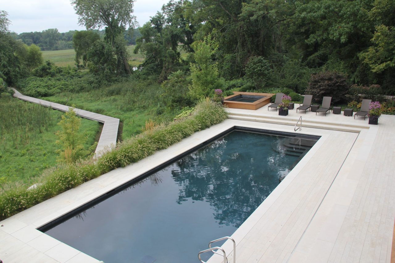 Contemporary rectangle pool with plank paving overlooking boardwalk